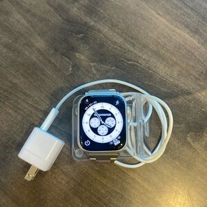 Apple Watch.   Strap included.  Charger stand and charger included